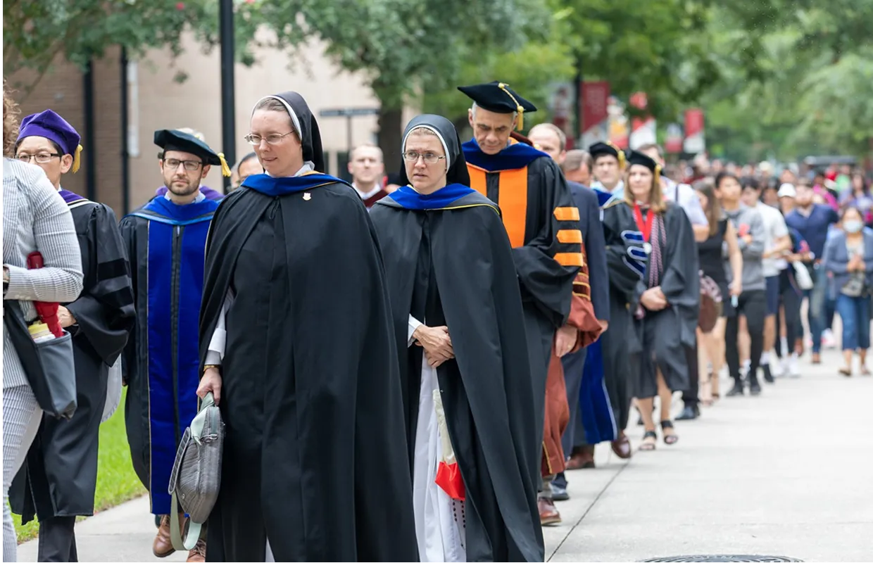 Sisters in a line to graduation_compressed A Sister and Professors in a line getting ready to walk into a graduation.