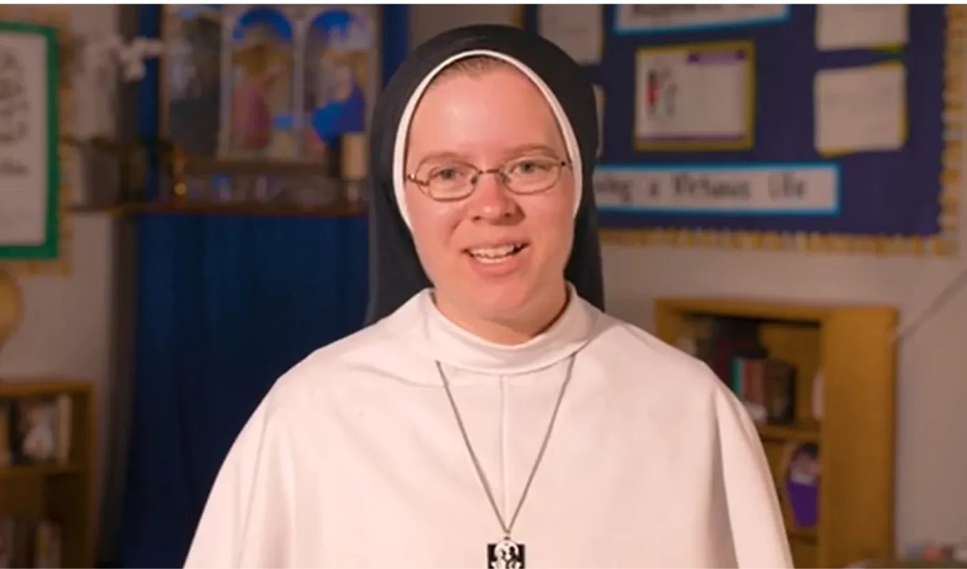 Sister in a classroom speaking to a camera about the virtues.