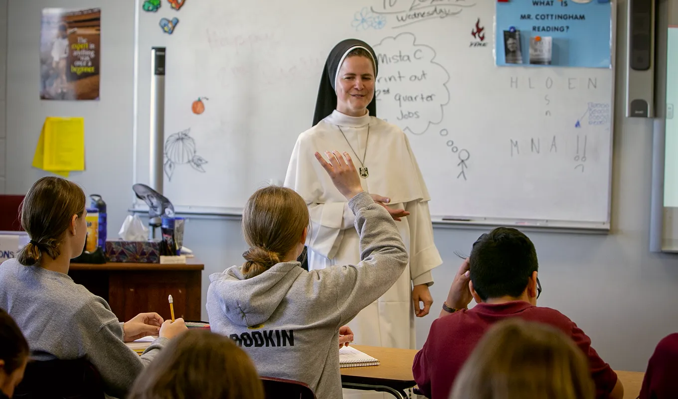 Dominican Sister teaching in a classroom to high school students.